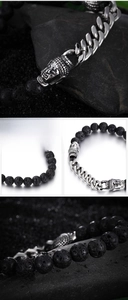 Detail of lava stone beads and silver buddha head charms on stainless steel chain bracelet