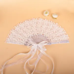 Elegant white lace folding fan with pearl accents and decorative long ribbon tassels