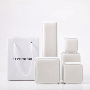 Detailed set of premium white velvet jewelry boxes with matching gift bag and ribbon