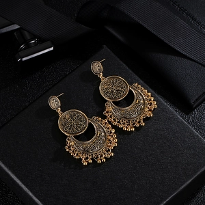 Bohemian vintage gold crescent tassel earrings with intricate filigree and beaded details