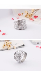 Macro view of wide silver band ring featuring multiple rows of clear pavé zircon stones