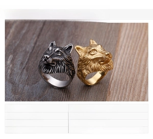 Detailed view of wolf head ring in steel and gold finish, high-quality stainless steel