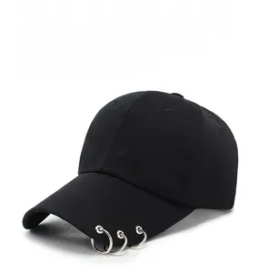 Detail shot of black wool-blend baseball cap with three decorative silver metal rings on brim