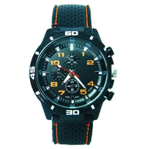 Macro shot of black chronograph watch face with orange accents and silicon strap stitching