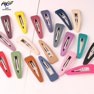 Close-up of matte macaron colored teardrop BB hair clips set with silver metal snap