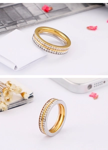 Macro detail of gold and silver double-row pave zircon rings in a modern stacked design