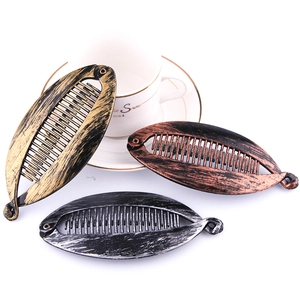 Vintage large banana hair clips in gold, bronze, and silver-black with painted texture