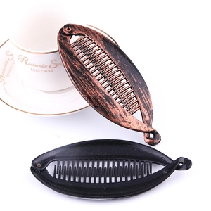 Detail of large banana hair clips in antique bronze and black finish with comb teeth