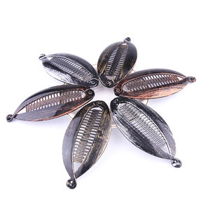 Vintage metal banana hair clips set in bronze and silver black finish on white background