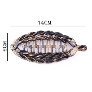 Macro view of vintage large fishtail hair clip with 14cm length and woven texture details