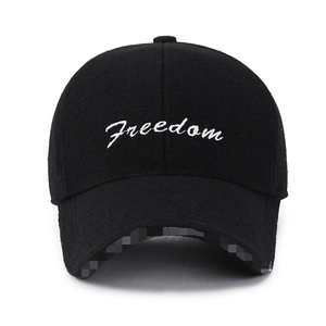 Front view of black wool baseball cap with white Freedom cursive embroidery