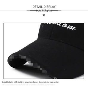 Detail of black wool baseball cap featuring a reinforced brim and white letter embroidery