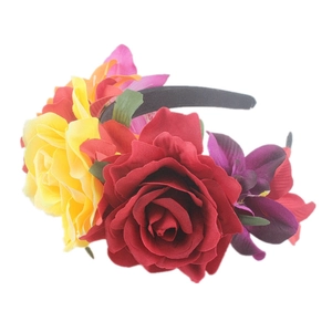 Detail of red and yellow fabric roses on a floral bridal headband for wedding parties