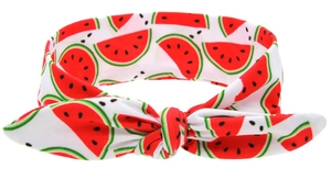 Close-up of white baby headband with red watermelon print and soft knot design