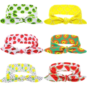 Detail view of six colorful stretch fruit-patterned headbands with cute knot design