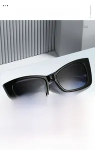 Detail of vintage square cat-eye sunglasses with crocodile texture temples and gradient lenses
