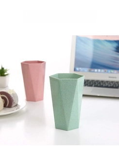 Detail of eco-friendly hexagonal toothbrush cups with matte finish in lifestyle setting