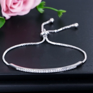 Detail of adjustable silver bolo bracelet featuring curved bar with white zircons