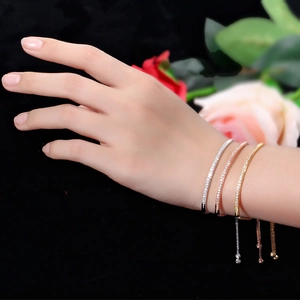 Set of three adjustable bracelets in silver, gold, and rose gold with micro-pave crystals