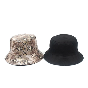 Detail showing snakeskin print and plain black PU reversible bucket hat for street fashion