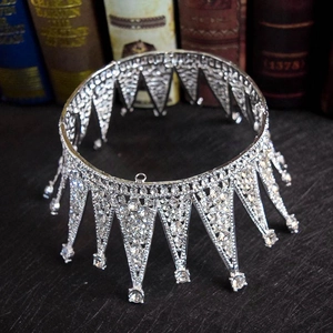 Elegant vintage silver bridal crown with shimmering crystals on a retro wooden surface