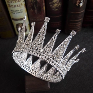 Close-up of vintage silver bridal tiara with rhinestones resting on retro books