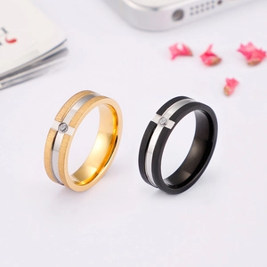 Brushed stainless steel couple rings in gold and black with single cubic zirconia