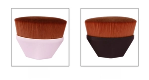 Detail view of pink and black hexagonal foundation brushes with dense soft bristles