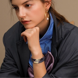 Fashion multilayer leather bracelet with gold bars and elegant white pearl drop earrings