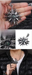 Macro view of vintage stainless steel compass pendant with embossed star detail