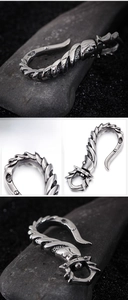 Detailed close-up of heavy-duty stainless steel fishhook pendant with spiral armor texture