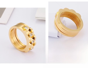 Detail of gold-plated wavy stainless steel ring with inlaid white zircon stones