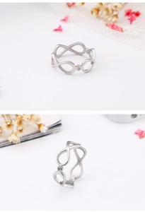 Detailed macro view of polished silver infinity ring with a sparkling crystal stone accent
