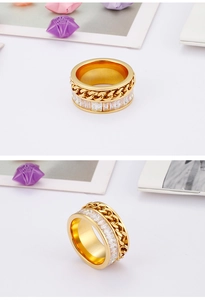 Detail of gold-tone chain ring featuring double layers and clear zircon stones