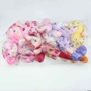 Detail of colorful plush fruit dolls in packaging showing braided hair and strawberry prints