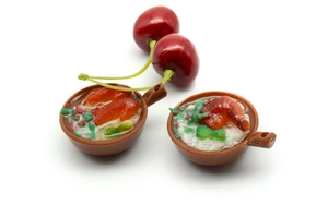 Detailed close-up of mini PVC food pendants featuring realistic clay pot rice with cherries
