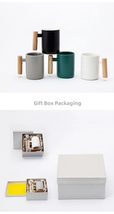 Detail of Nordic ceramic mug gift set with wooden handle, gold spoon and coasters