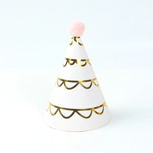 White birthday party hat with gold wave patterns and a pink pom pom on top