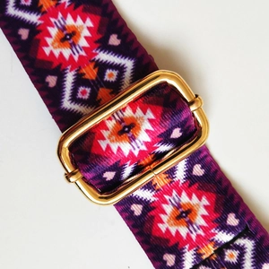 Detail of colorful ethnic weave strap with adjustable gold metal buckle for bags