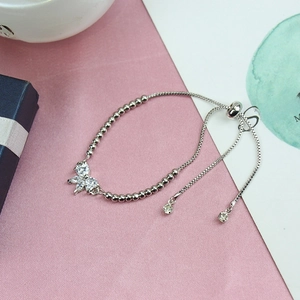 Detail of silver-tone adjustable bracelet with sparkling zircon butterfly charm and bead chain