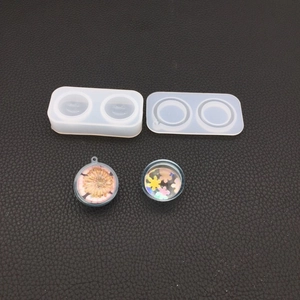 Detailed view of DIY translucent silicone sphere molds and floral resin pendants