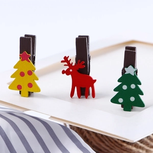 Set of Christmas wooden clips featuring colorful tree and reindeer shapes for photo hanging