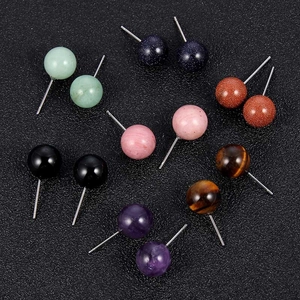 Macro shot showing diverse 10mm round natural stone stud earrings in multiple colors