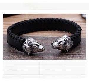 Detailed close-up of a stainless steel double-headed bear braided leather cuff bracelet