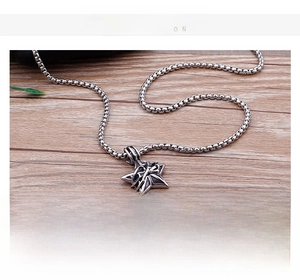 Detail of a vintage steel star pendant with technical specs on a wooden background