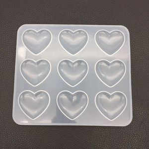 Close-up of a 9-cavity heart shaped silicone mold for DIY resin crafts and candle making