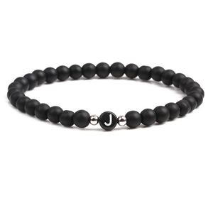 Detail of 6mm black matte bead bracelet with white letter J and silver metal spacers