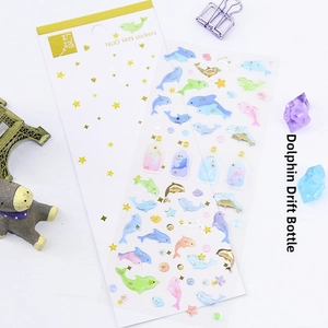 Detail of dolphin and drift bottle PET stickers with gold foil for scrapbooking