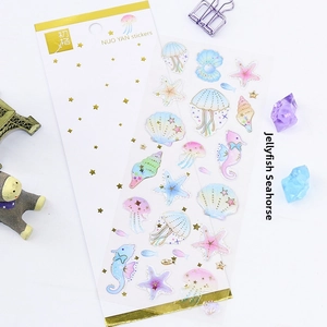 Detail of marine life stickers with gold foil jellyfish and seahorse patterns