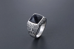 Macro shot of silver titanium ring featuring a square blue sandstone and Greek key relief